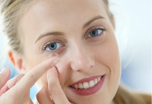 Woman putting in a contact lens